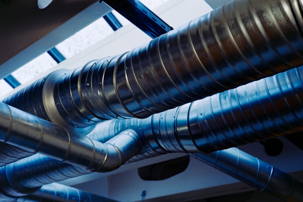 Close-up of a modern metallic ventilation system in an industrial setting.